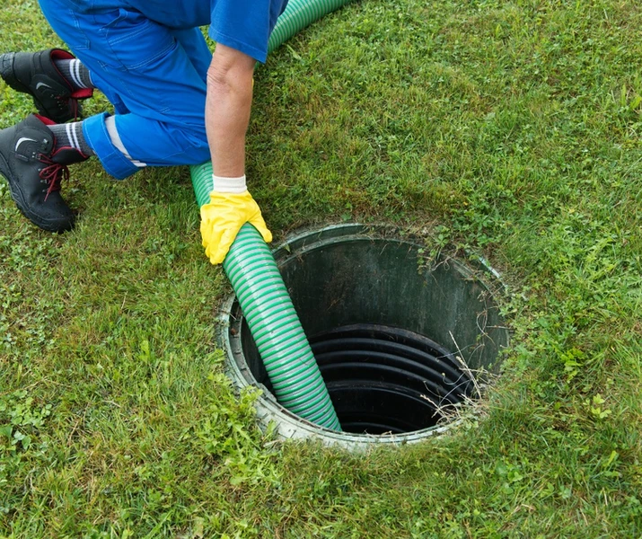 man holding hose for septic pumping